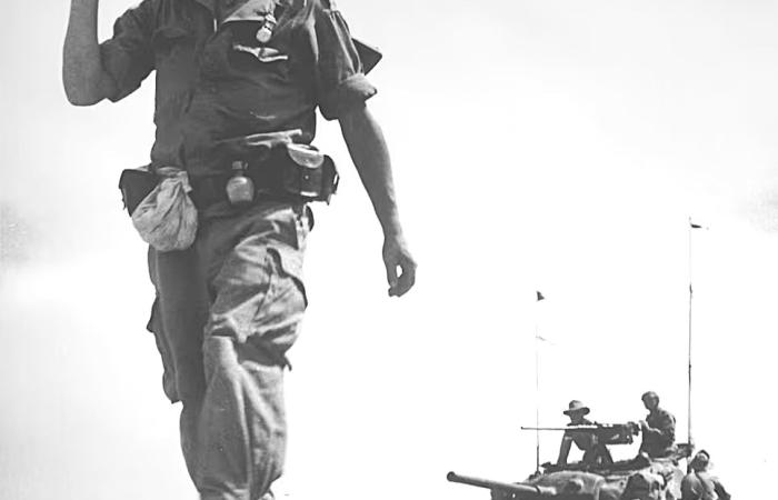 French soldier on foot in Vietnam in front of a U.S.-supplied tank