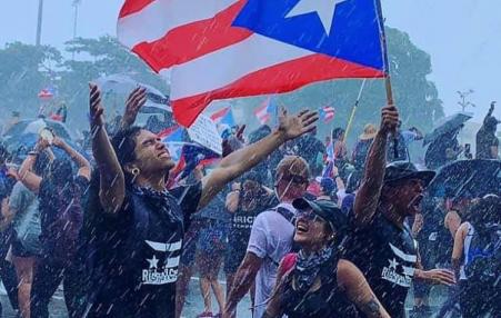 Protesters rejoicing in the rain in San Juan, Puerto Rico