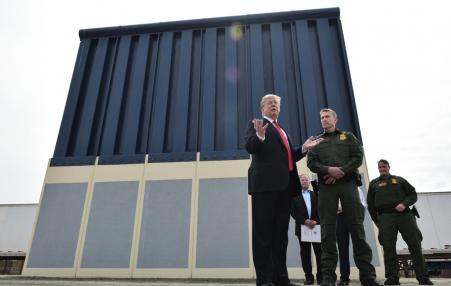 Trump standing in front of sample wall
