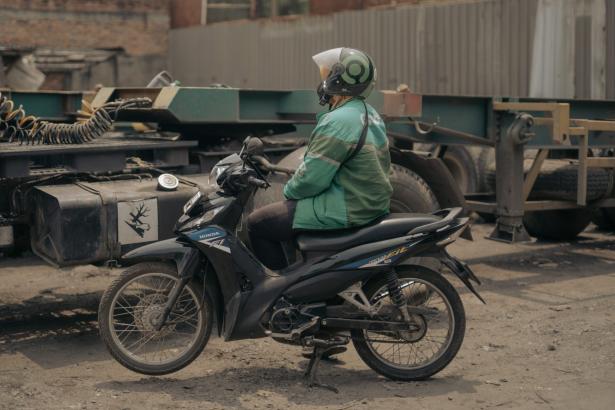 Photo of a woman on a motor bike. 