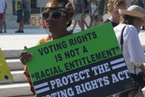 A protester decries the 2013 Supreme Court ruling on the Voting Rights Act.