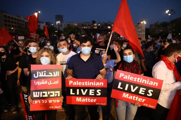 Thousands of Palestinian and Israeli protesters take part in an anti-annexation demonstration in Tel Aviv. 