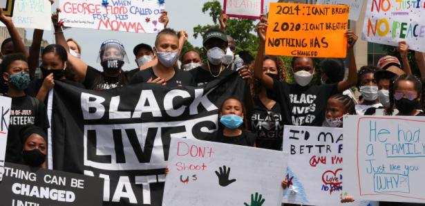 Workers at a rally with Black Lives Matter Signs