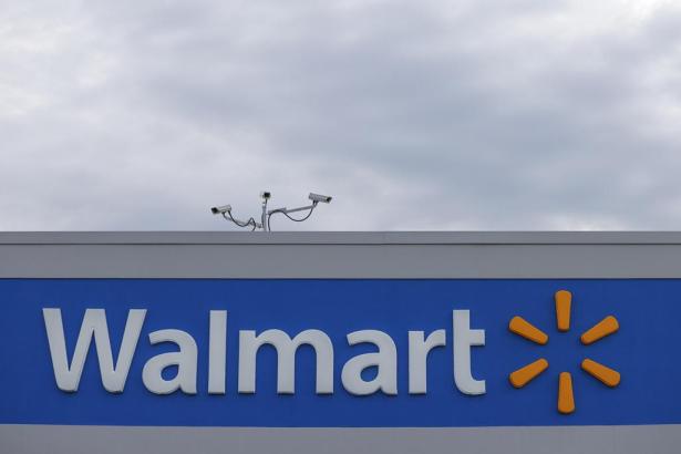 Photo of the top of a building with the logo for Walmart front and center.