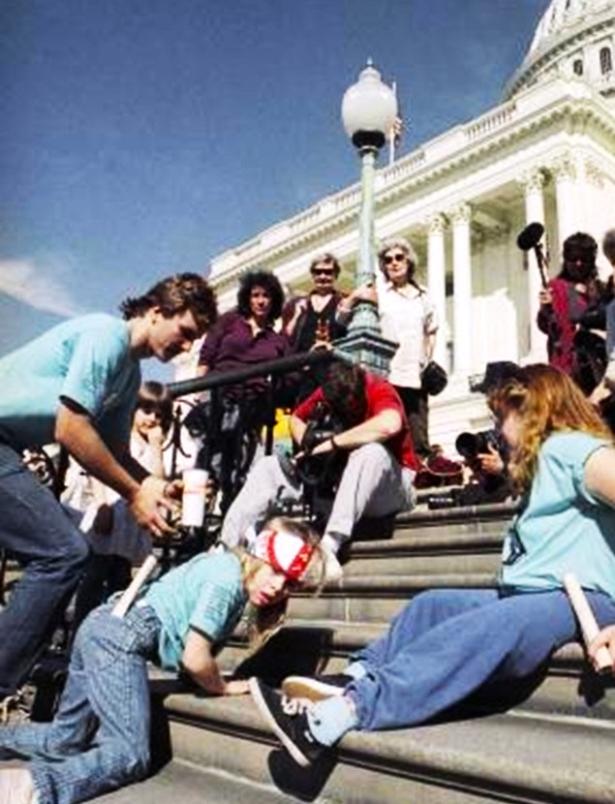 Other-abled protesters crawling up the steps of the Capitol