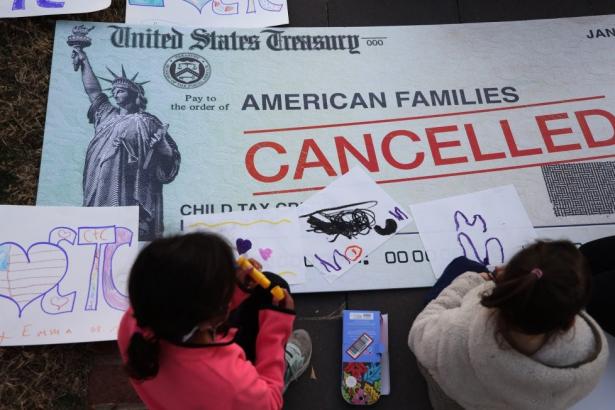 photo of a canceled US Treasury check to american families with two children drawing in the foreground