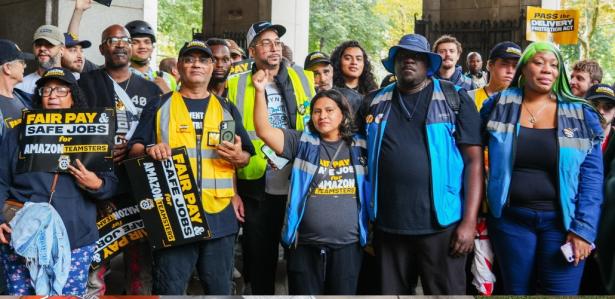 Photo of workers with signs reading "fair pay safe jobs"