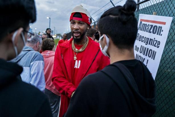 Organizer, Chris Smalls facing people whose backs are in the foreground.