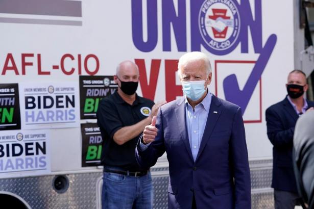 Biden in a mask with union members.