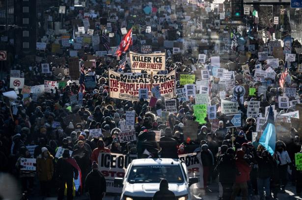 photo of protesters with signs against ICE