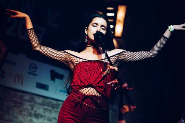 Woman performing at  a microphone