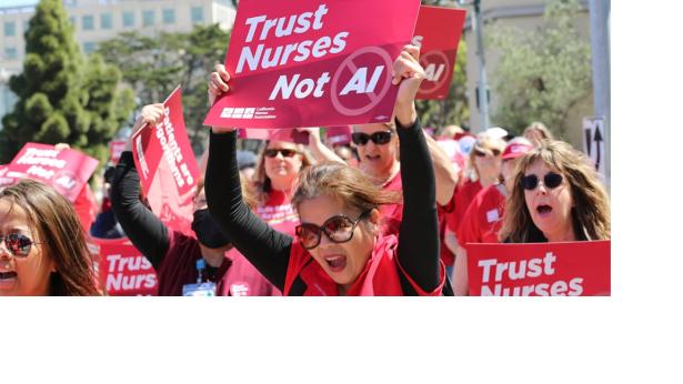 Photo of Nurses in red scrubs rallying .
