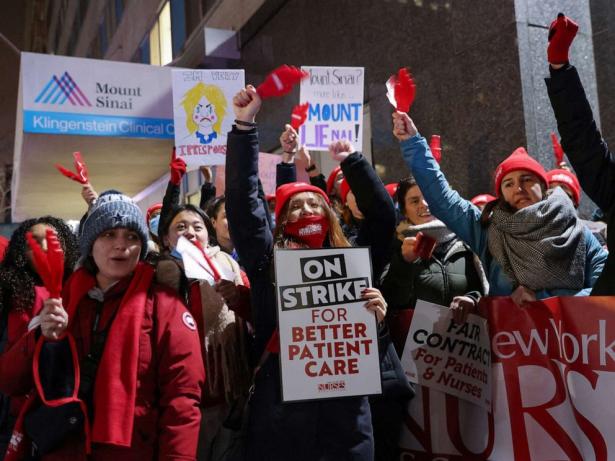 Nurses with signs rallying.