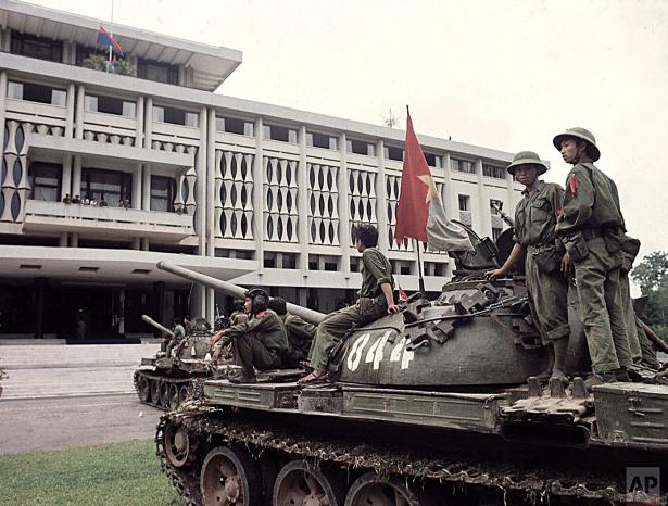 Two military tanks belonging to the People's Revolutionary Government stand outside the Saigon regime's headquarters building on April 30, 1975