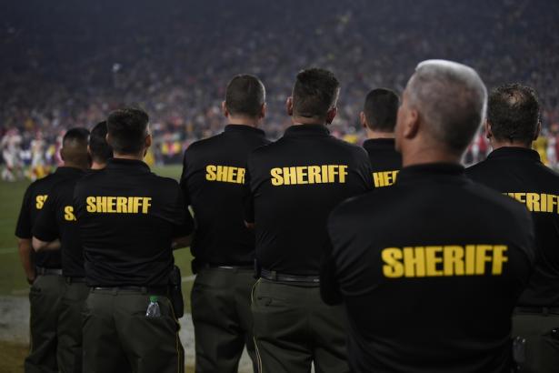 Sheriff’s deputies on the sidelines of a National Football League game.