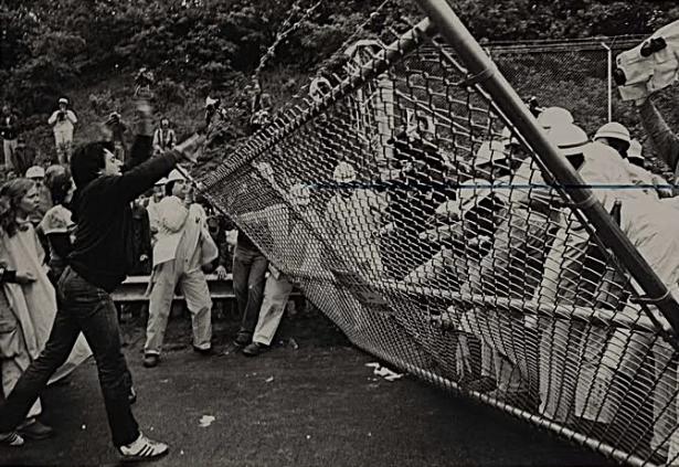 Anti-nuke demonstrators pulling down a fence at the Shoreham construction site