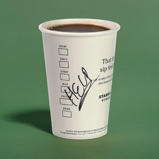 Photo of a Starbucks coffee cup with HELP written across it. 