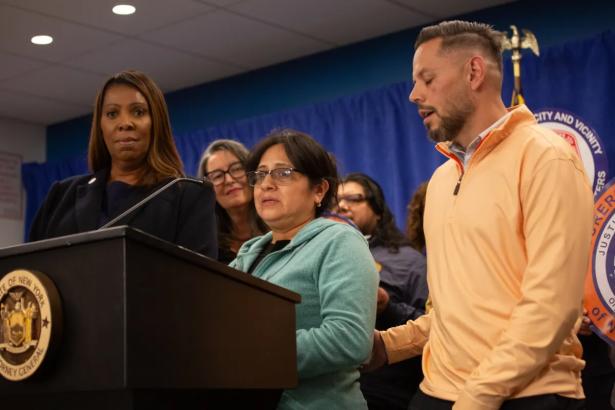Photo of workers speaking at a press conference with Tish James in the background. 