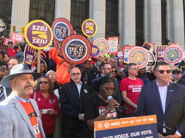 Photo of union leaders and members on the street with union signs
