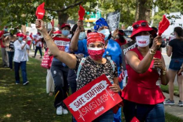 Photo of a group of nurses rallying with signs 