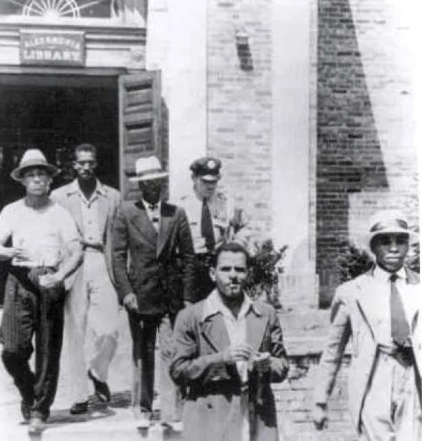 5 arrested demonstrators being escorted out of a Jim-Crow library