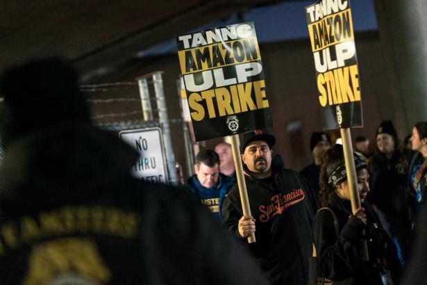 photo of striking workers holding signs.