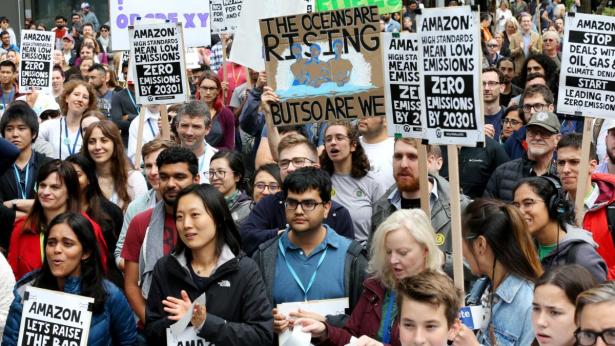 Photo of many people at a protest with signs.