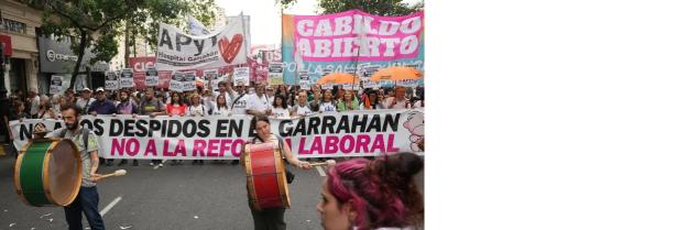 Photo of the front of a huge ``march with banners and signs.