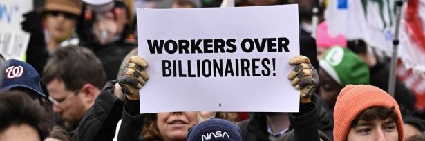 A person holds up a sign as they protest against U.S. President Donald Trump and Elon Musk's Department of Government Efficiency  A person holds up a sign as they protest against U.S. President Donald Trump and Elon Musk's Department of Government Efficiency (DOGE) in Washington, D.C. on February 5, 2025. (Photo: Drew Angerer/AFP via Getty Images)