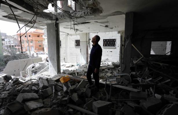 man looking at devastated building