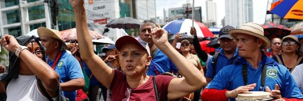 Marchers on the street with raised hands.