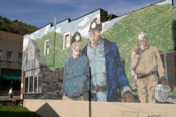Photo of a painted mural of three coal miners.