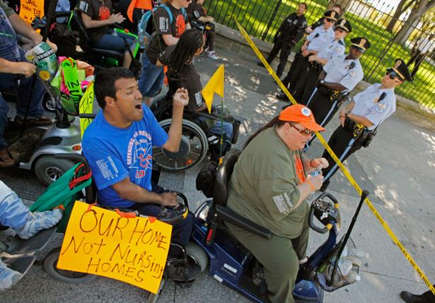 People in wheelchairs confronting police