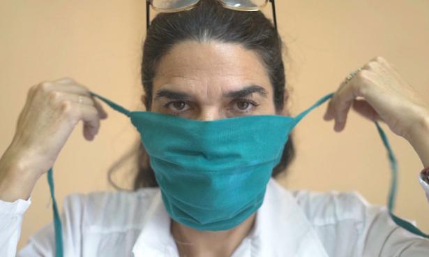 Cuban doctor putting on mask