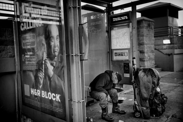 unhoused man at bus stop