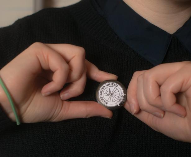 Hands holding a Kickstarter United button 