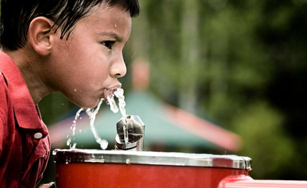 Latinx child drinking water