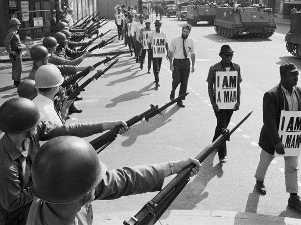 Sanitation workers marching in Memphis threatened by national guards.