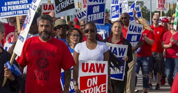 workers marching with picket signs