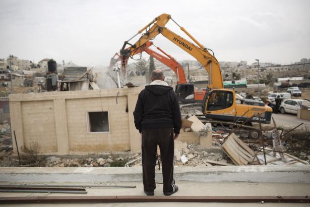 Man watching home being destroyed