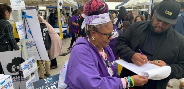 woman siging petition