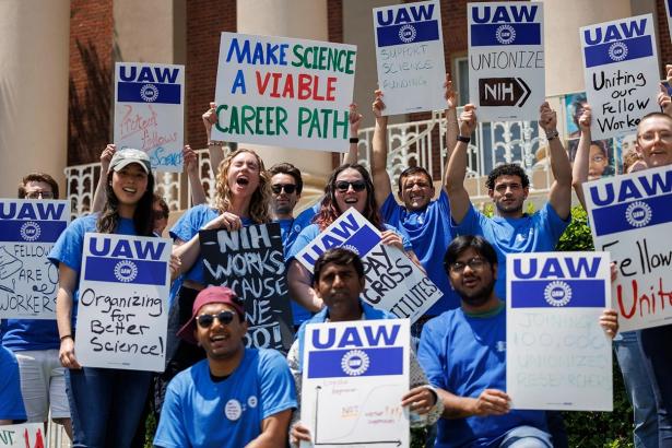 photo of workers holding signs - UAW 