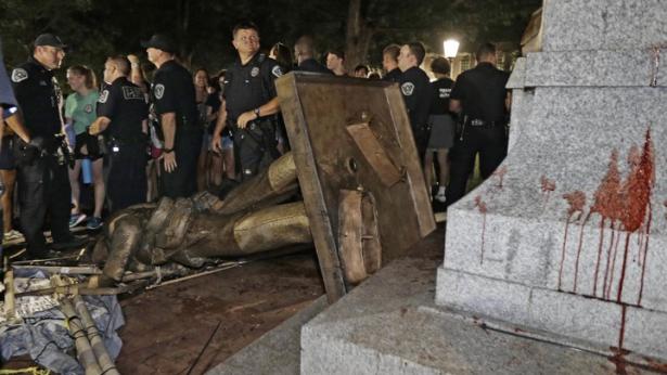 Police stand guard after Silent Sam was toppled at the University of North Carolina on Monday.