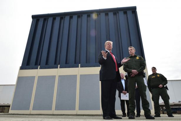 Trump standing in front of sample wall