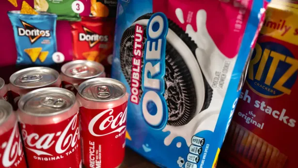 In this photo illustration, food products manufactured by Mondelez and Coca-Cola are shown on December 11, 2024 in Chicago, Illinois. 