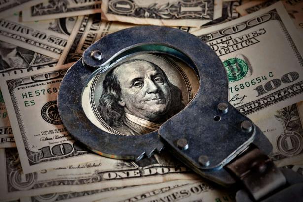 dollar bill with handcuffs