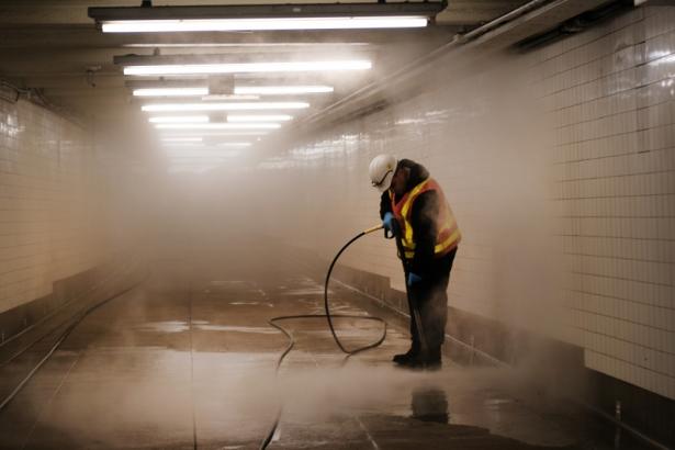 Worker seen cleaning a subway station