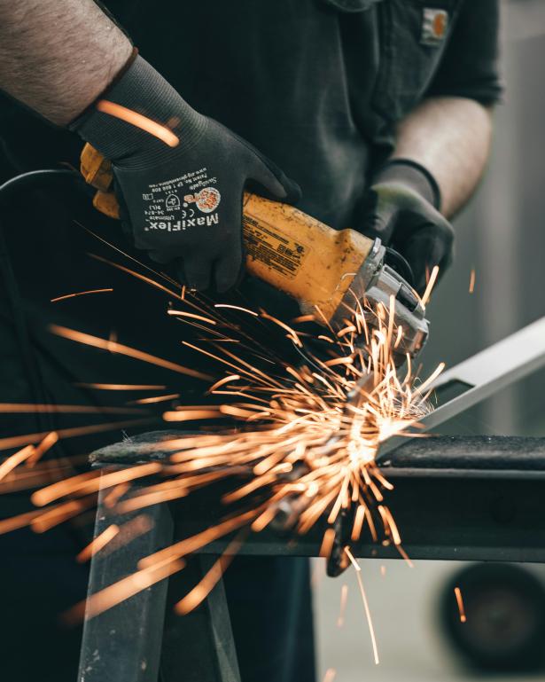 fire shooting out as a welder welds.