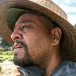 Face of a farmworker in a straw hat.