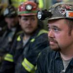 Up-close photo of miners with helmets.